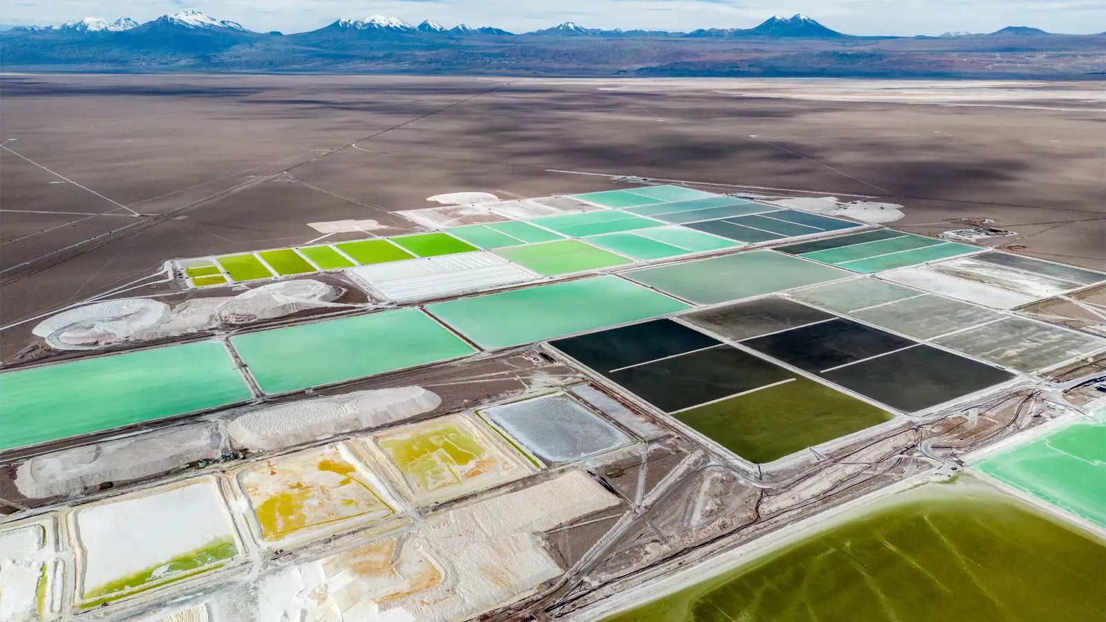 Aerial view of lithium evaporation ponds used in battery mineral production, highlighting mining conditions to evaluate before selecting the best slurry pump based on flow, solids handling, reliability, operating cost, and long-term performance.